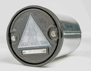 Black monitoring well head with 'Do Not Fill' warning