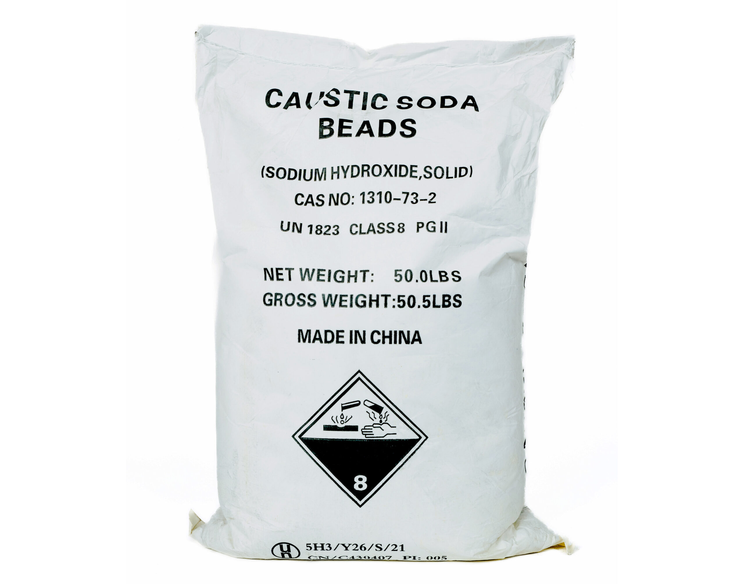 A white bag of caustic soda beans with the following labels: “Caustic Soda Beads (Sodium Hydroxide Solid) Cas No: 1310-73-2. UN 1823. Class 8. PGII. Net Weight: 50.0lbs. Gross Weight: 50.5lbs. Made in China."