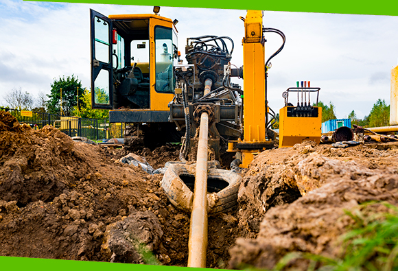 a large piece of equipment moving a pipe