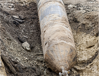 large metal object in a pit of dirt