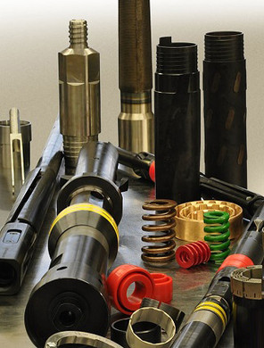 A variety of overshot assembly parts on a table.