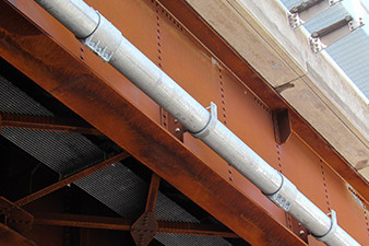 a pipe along a steel support beam