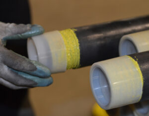 Putting a cap on a Drillers Edge rod after it’s been protected with thread shield.